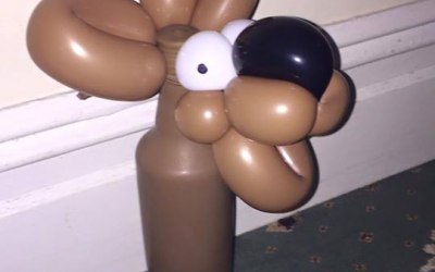 Bottle of wine wrapped in a balloon