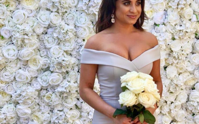 Bridesmaid striking a pose infront of our Aphrodite Flower Wall