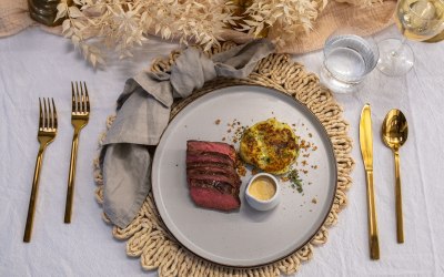 Seared onglet, braised potato cake, burnt hollandaise, crispy onions