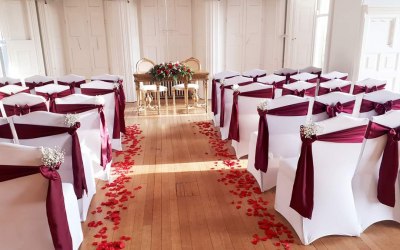 Aisle decor, chair covers, satin sashes. Rose petals and gypsophilia 