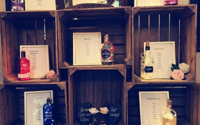 Rustic table plan, gin bottles and lights