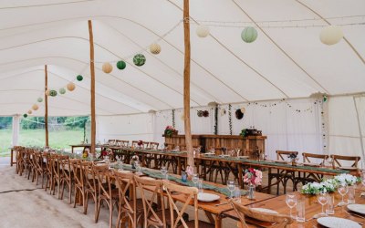 'Rosebury' 12x21m stretch marquee in white, with rustic furniture and bar