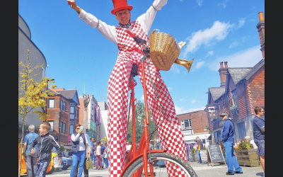 Stilt walking, lofty cycling entertainment.