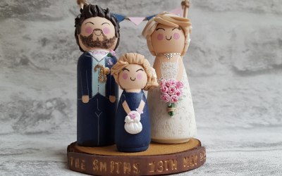 Family wood and clay bride and groom with flower girl clay toppers.