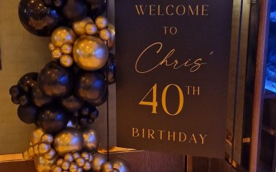 bespoke black welcome board with black stand and balloon garland to match