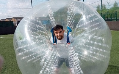 A Stag on his  stag weekend playing bubble soccer games