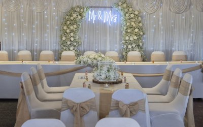 Delicate whispers broken arch with mr and mrs neon sign for wedding reception