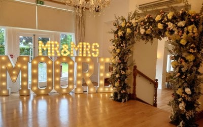 Light up letters and floral arch decor