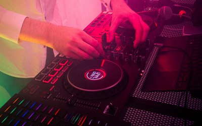 Closeup on DJ decks during song crossfade