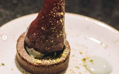 GF brownie, wine poached pear, pistachio dust