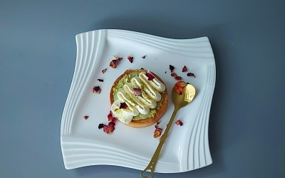Tartlet filled with raspberry jelly and with pistachio cream,topped with whipped cream 