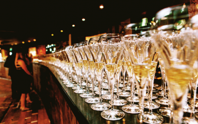 Bar filled with champagne flutes and people enjoying a drink