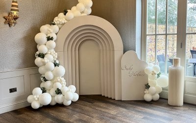 7ft 3D arch, with middle filled in & balloon arch with a small personalised board and cake stand 
