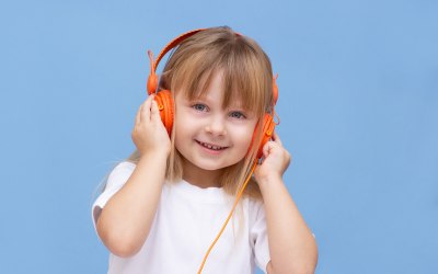 Happy child listening to music at the Scinec of Sound