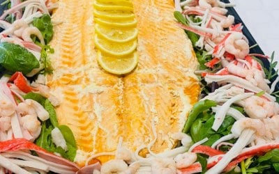 Freshly cooked side of salmon with seafood garnish 