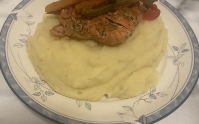 Creamy garlic mash topped with pan fried Cajun salmon with sautéed vegetables 