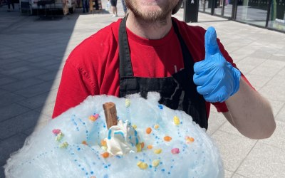 Tom the owner with one of our Cloud 99 Ice creams which is a waffle cone with Jersey dairy ice cream, a soft cloud of candy floss and then topped with a flake sauce and two toppings of your choice.