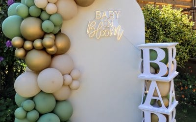 Sailboard backdrop with neon sign and BABY blocks.