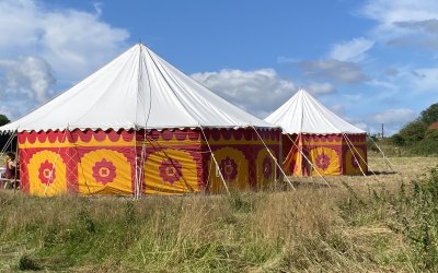 A pair of matching tents set up for a local fate
