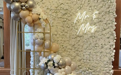 Wedding setup Ft the white rose flower wall, neon ‘mr & Mrs’ & the golden window with balloons