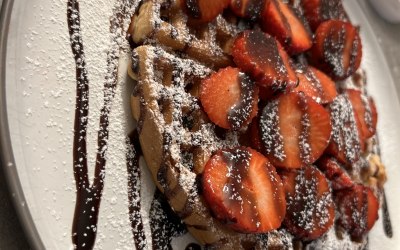 Belgian waffle with, strawberries, drizzled dark chocolate and Nutella