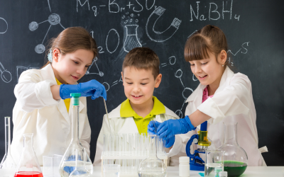 Kids in lab coats, exploring Science utensils