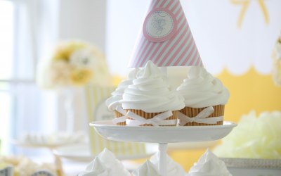 Etagère filled with cupcakes and party hats