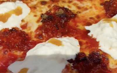 A closer look at a Nduja, stracciatella, hot honey pizza fresh out the oven