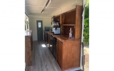 fully equipped with three large bottle fridges and a wine bottle fridge. The trailer also has a microwave food prep area a sink and a slush machine. It also has two standard under counter fridges and a slush machine 
