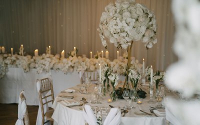 White rose and orchid wedding table centre pieces with top table floral styling