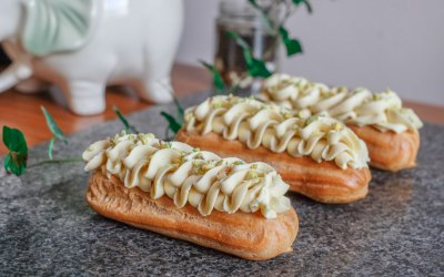 Pistachio mousseline eclairs with white chocolate and pistachio chantilly ripple with crystallised pistachio crumb.