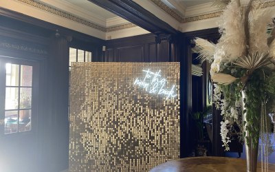 Sequin wall with neon sign
