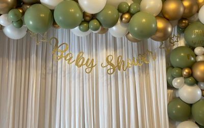 Baby shower balloon garland with satin curtain backdrop