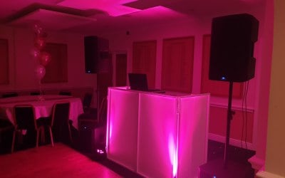 2 Pink Uplights, 4 Speakers and a DJ Booth 
