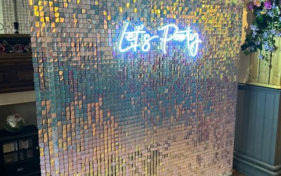 Sequin wall and neon sign