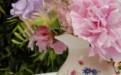 Vintage jugs, teapots, cut glass vases, decorated jam jars and milk bottles for decorations.