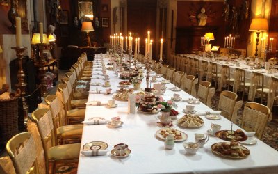 Beautiful formal afternoon tea with vintage china, table decorations and chair sashes.