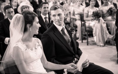 Groom looks at his bride on their wedding day in church 