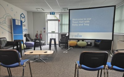 Dry hire projector, screen & Microphones on table for hybrid meeting using zoom