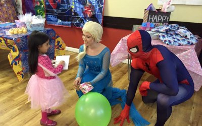 Elsa and Spider Man greeting the birthday girl 