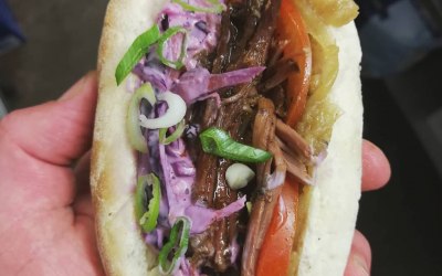 slow cooked coffee and cardamon brisket po boy served with a red eye bbq sauce and red cabbage slaw