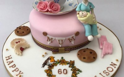 A bespoke cake for a 60 year old former midwife who loves cups of tea, biscuits and Robins!
