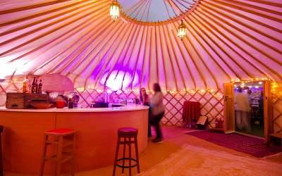 A large yurt with a round bar for drinking at. 