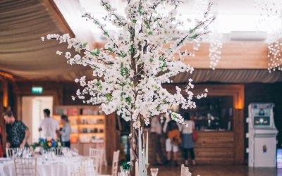 Luxury Blossom Tree Centrepieces at Elmore Court, Gloucestershire: https://www.aislehireit.co.uk/blossom-trees-table-centrepiece Photo Credit: Laura Power Photography