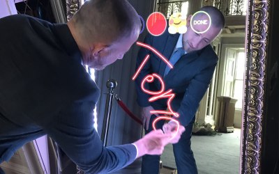 A guest at a Corporate Event signing the Mirror