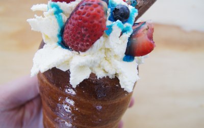 chimney cake cone with whipped cream, fresh fruits and flake