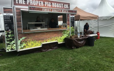 Pig roast trailer accompanied by the spinning spitting pig roast