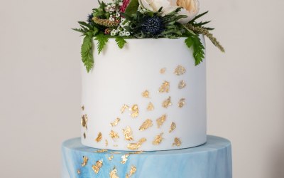 Fresh edible flowers on marbled cake