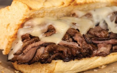 steak with melted cheese served in baguette