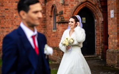 bride behind groom posing